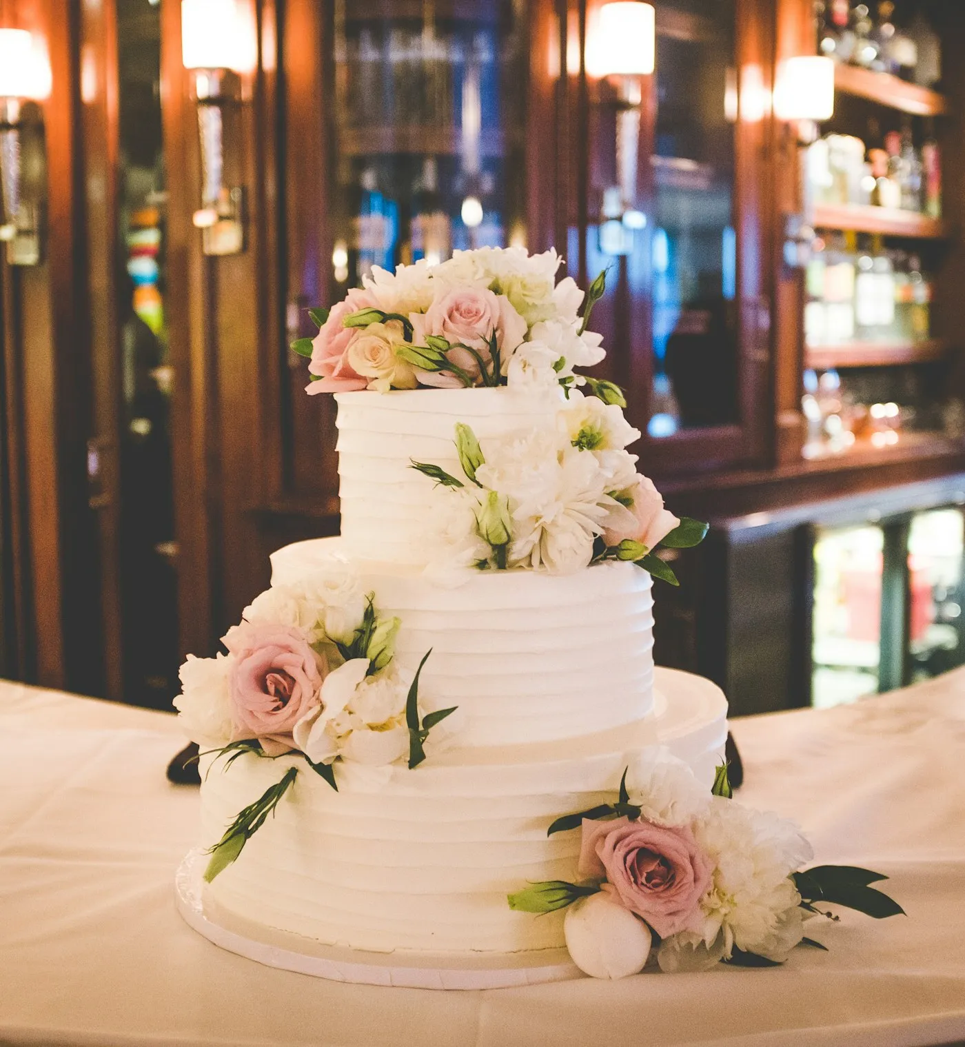 Minimal three-tier white fondant cake.